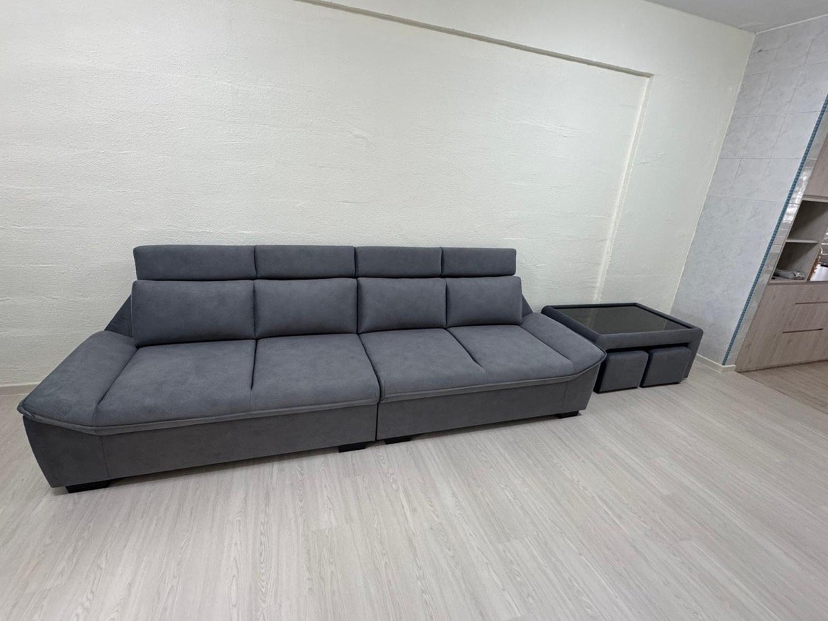 Grey four-seater sofa and matching coffee table with stools installed in a customer's HDB living room