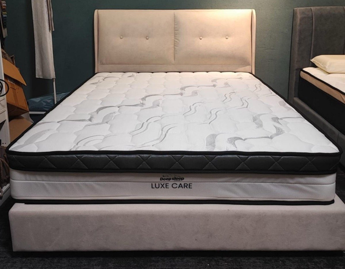 Luxe Care 10-inch Euro-top mattress on a beige divan bedframe in the showroom